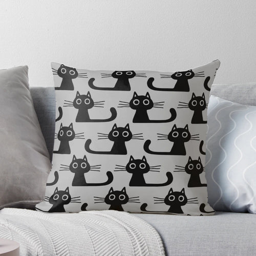 Soft, plush black kitten pillow with wide eyes and cute expression