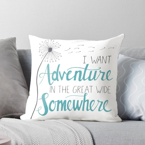 Decorative adventure-themed pillow with hand-lettered inspirational quote