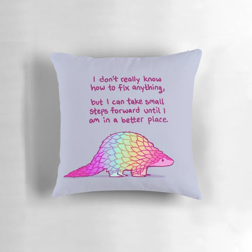A soft, rainbow-colored pangolin pillow with a message of self-love and mental health affirmations.