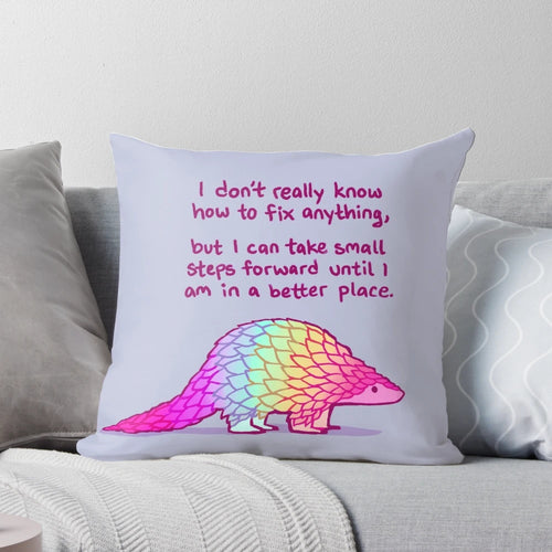 A soft, rainbow-colored pangolin pillow with a message of self-love and mental health affirmations.