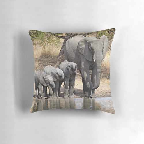 Soft, plush elephant pillow featuring a mother elephant and her baby calves in a serene, natural setting.