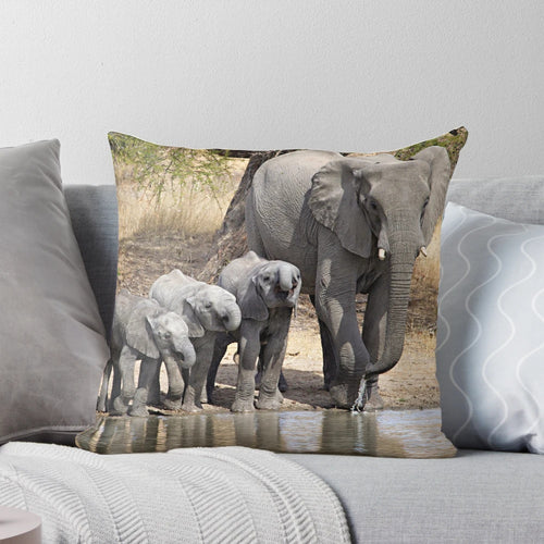 Soft, plush elephant pillow featuring a mother elephant and her baby calves in a serene, natural setting.