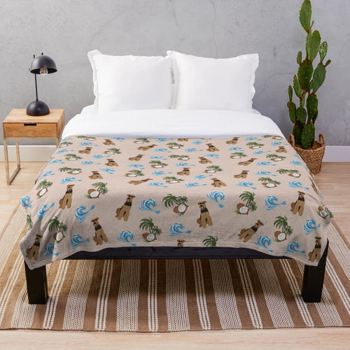 Airedale Terrier dog wearing sunglasses on a plush blanket with a summer pattern of sea waves and coconut palm trees