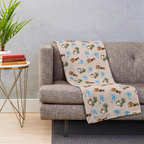 Airedale Terrier dog wearing sunglasses on a plush blanket with a summer pattern of sea waves and coconut palm trees