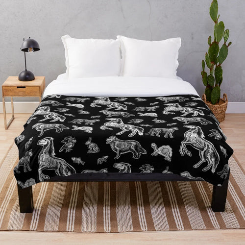 Plush blanket featuring an x-ray anatomy design of animal bones and skeletons