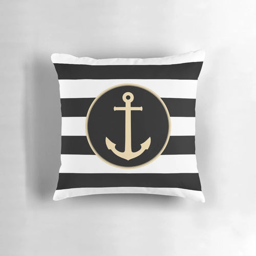 Black and white striped pillow with a gold anchor design, perfect for coastal or modern home decor.