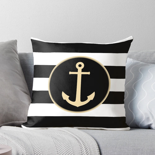 Black and white striped pillow with a gold anchor design, perfect for coastal or modern home decor.