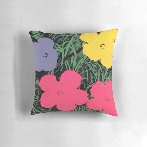 Colorful floral pillow with pink and yellow flowers in the style of Andy Warhol's pop art paintings