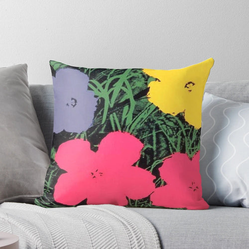Colorful floral pillow with pink and yellow flowers in the style of Andy Warhol's pop art paintings