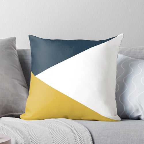 Angled color block pillow with navy blue, light mustard yellow, and white geometric design