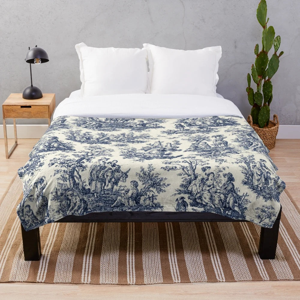 Soft, cozy plush blanket featuring a classic toile de jouy pattern in navy and white