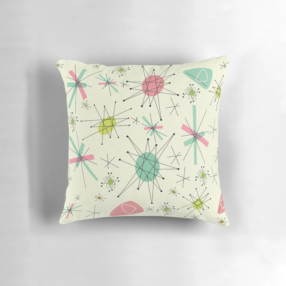 Vibrant atomic-inspired 50s pillow featuring a pink and blue geometric pattern