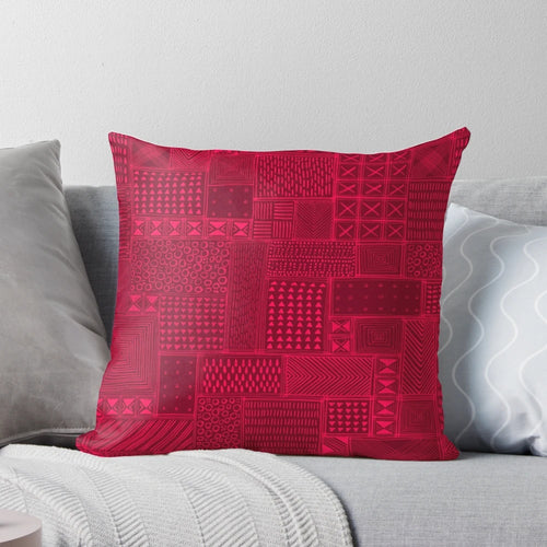 A vibrant red and black tribal-inspired mud cloth design decorative pillow for African-themed home decor.