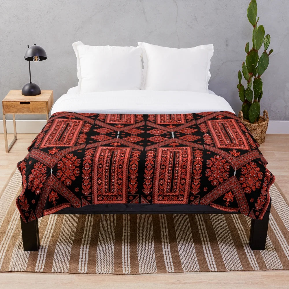 Palestinian embroidered plush blanket featuring traditional red and black designs