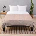 Beige plush blanket with leafy botanical design