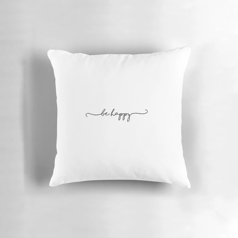 Be Happy" script text on a white decorative pillow, a mood-boosting home accent.