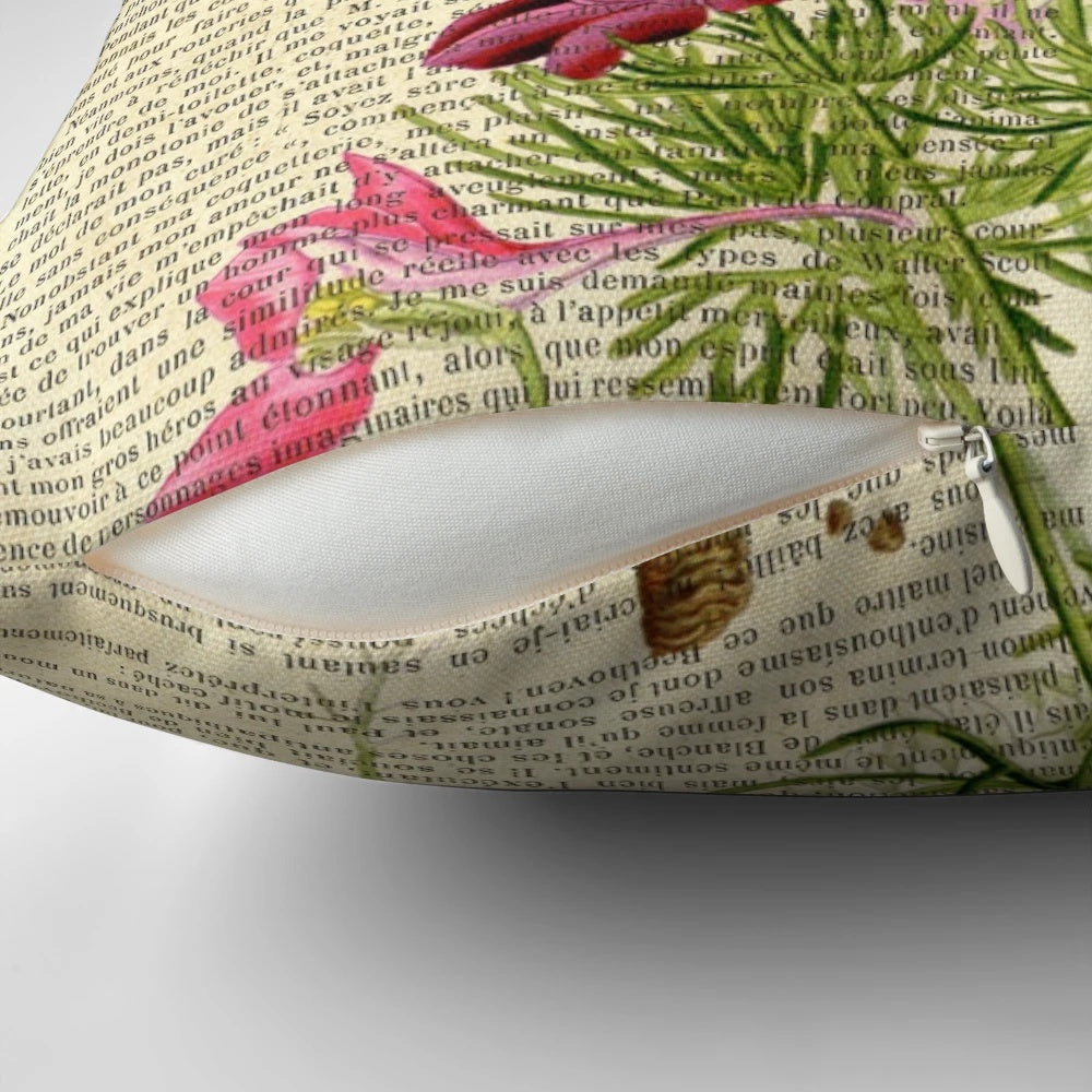 Closeup of a botanical print pillow featuring pink garden flowers on an aged, vintage-style book page.