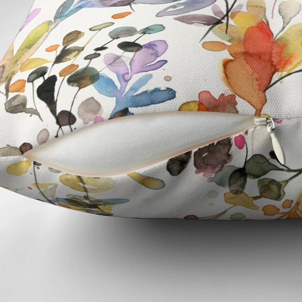 Vibrant watercolor painting of wild flowers and plants printed on a soft, plush pillow for a nature-inspired home accent.
