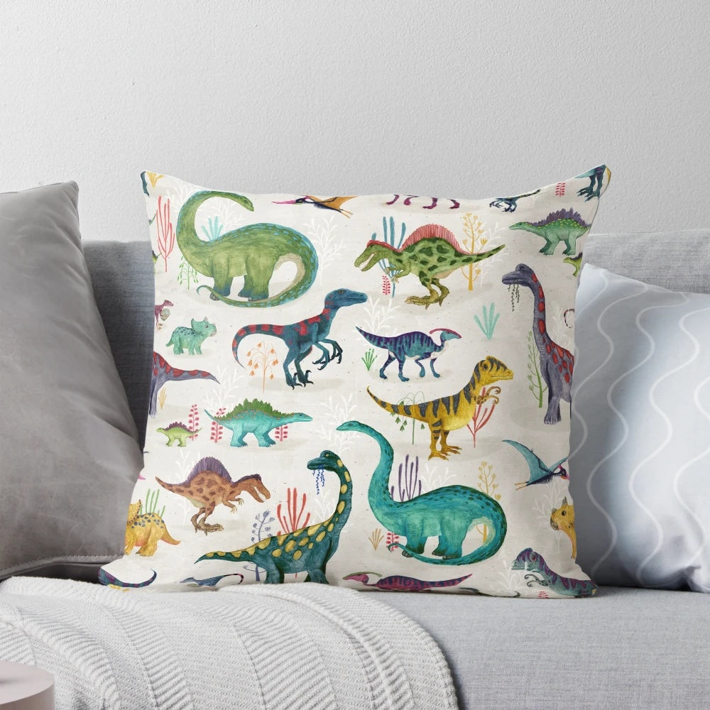 Vibrant dinosaur-themed pillow with various prehistoric plant-eating dinosaurs in blue, green, yellow, pink, and red colors