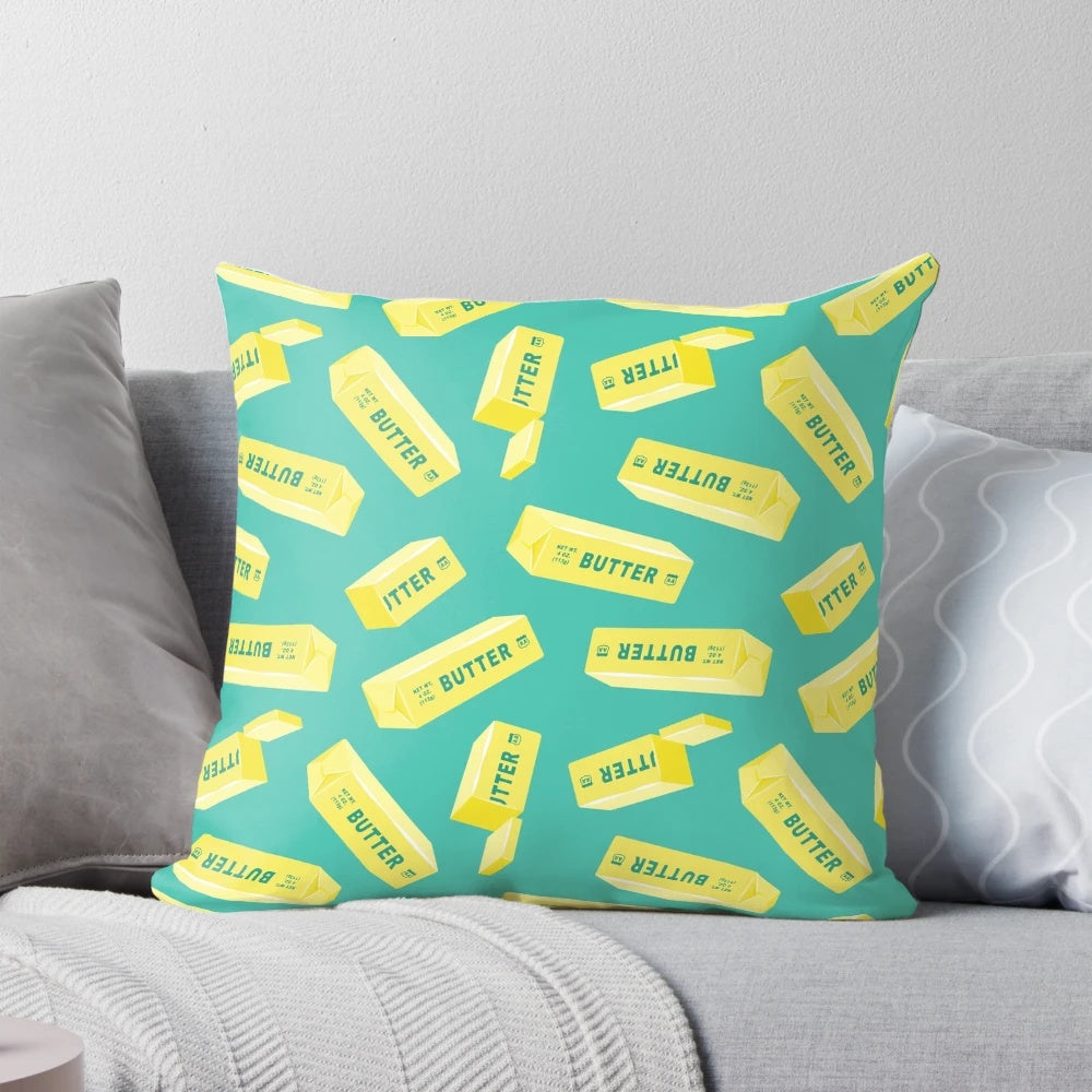 Teal pillow featuring a butter design, perfect for butter lovers and kitchen decor