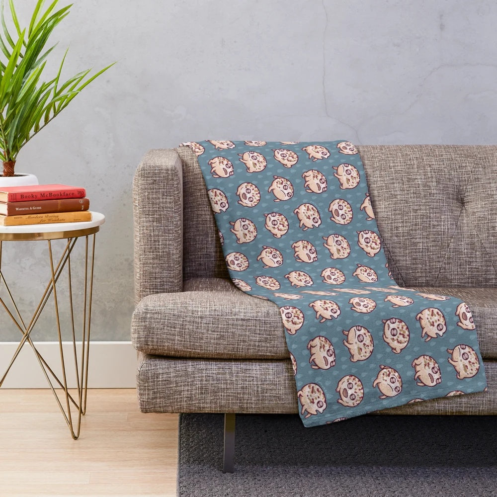 A cozy desert rain frog plush blanket featuring a delightful repeating pattern design.