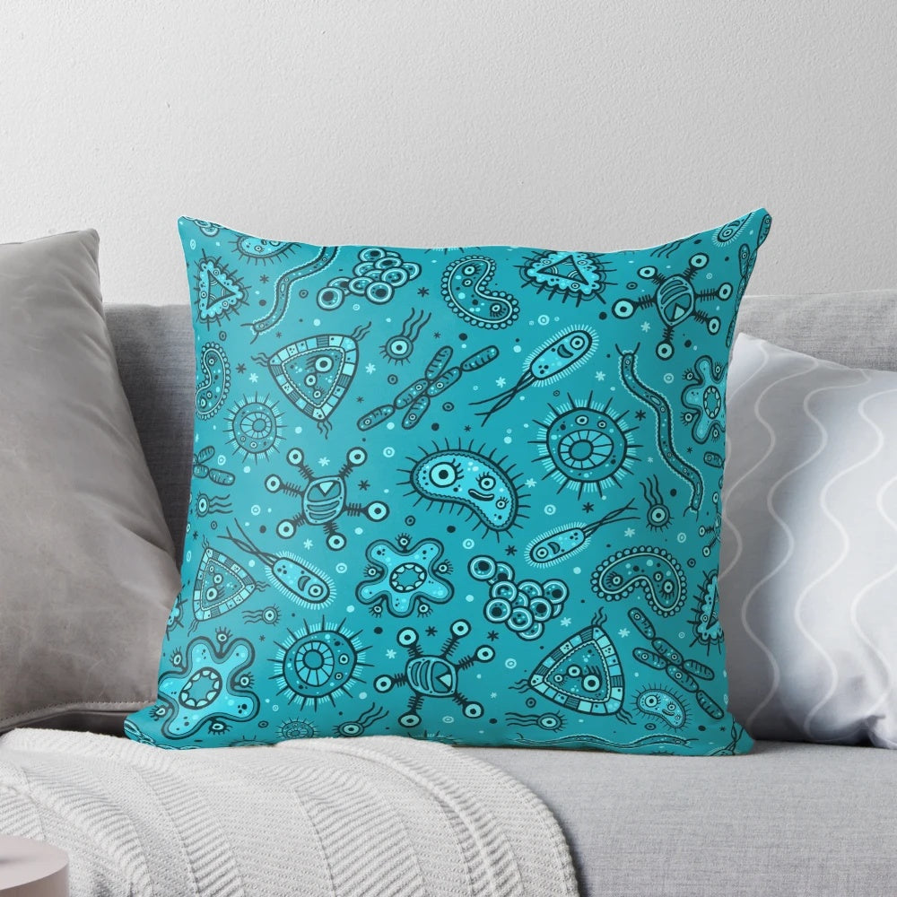 Teal decorative pillow featuring a whimsical cartoon pattern of microbes and germs.