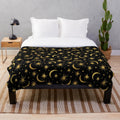 Soft and plush galaxy-themed blanket with stars, moons, and cosmic elements