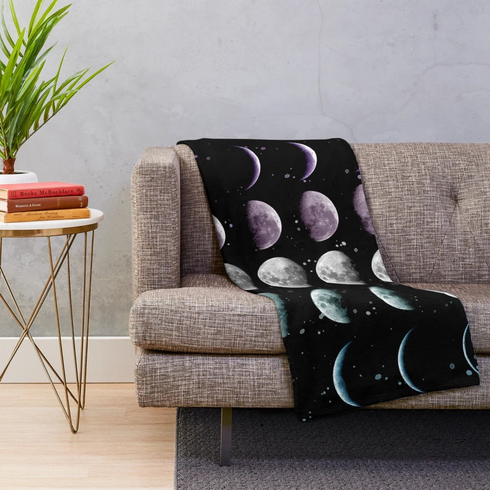 Cozy plush blanket with moon phases and celestial design