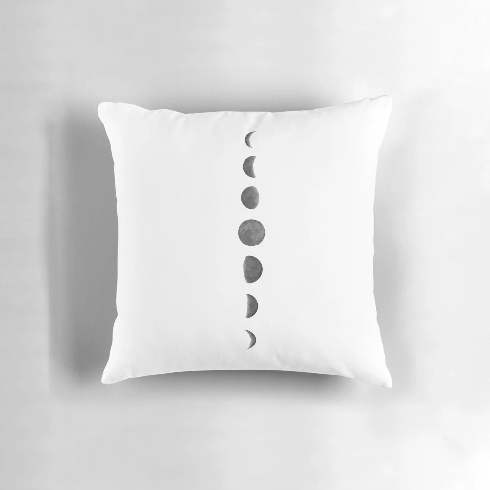 Soft, decorative pillow featuring phases of the moon and stars against a dark night sky background