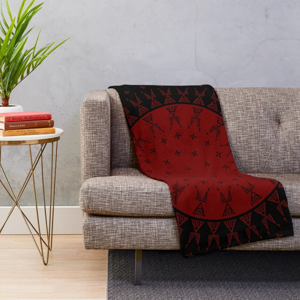 Maroon plush blanket with night sky and celestial motifs inspired by Native American art