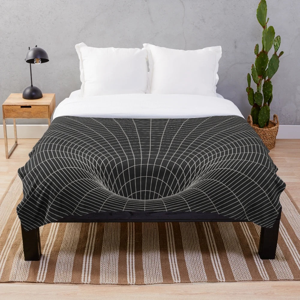 A plush, cozy blanket featuring a cosmic, sci-fi inspired design with elements like black holes, event horizons, and galaxies.