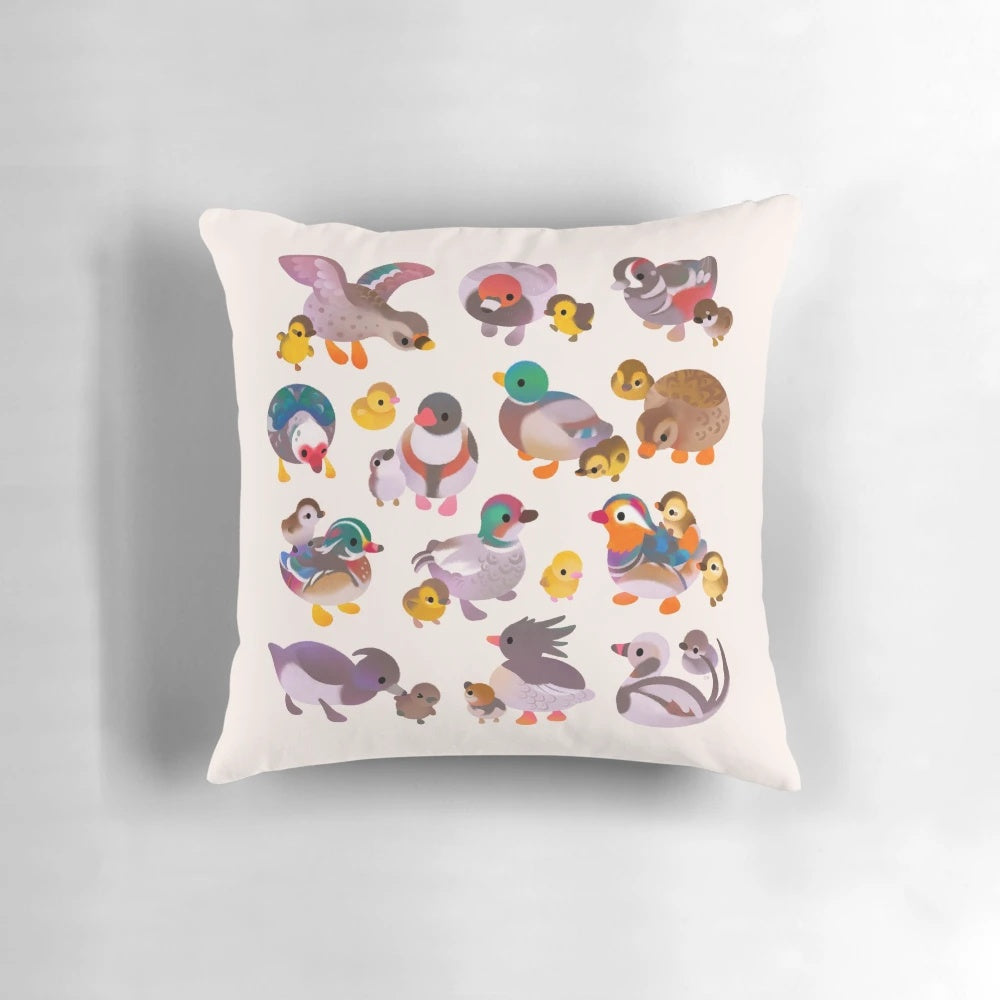 Decorative pillow featuring a hand-drawn illustration of a duck and her duckling on a wooden background.