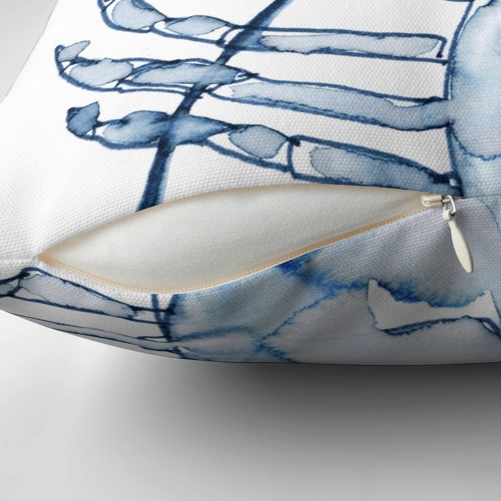 A watercolor painting of a coastal lobster in shades of blue and white, featured on a decorative throw pillow.