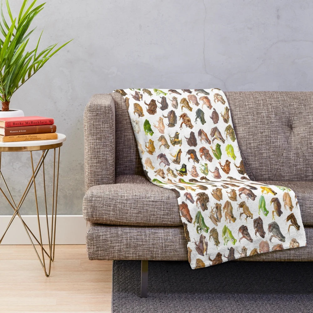 Plush blanket featuring a colorful illustration of 101 frog species found in Madagascar