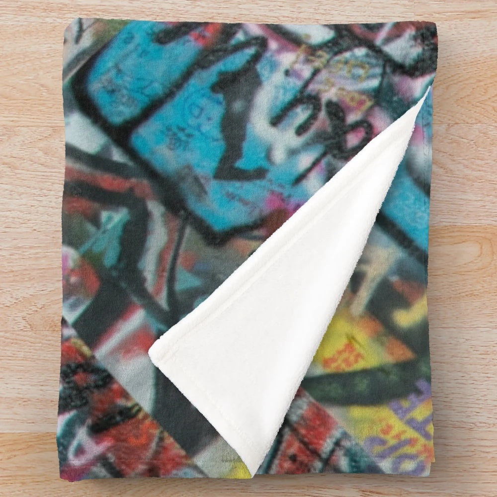 Graffiti pattern plush blanket with abstract, vibrant colors and urban style