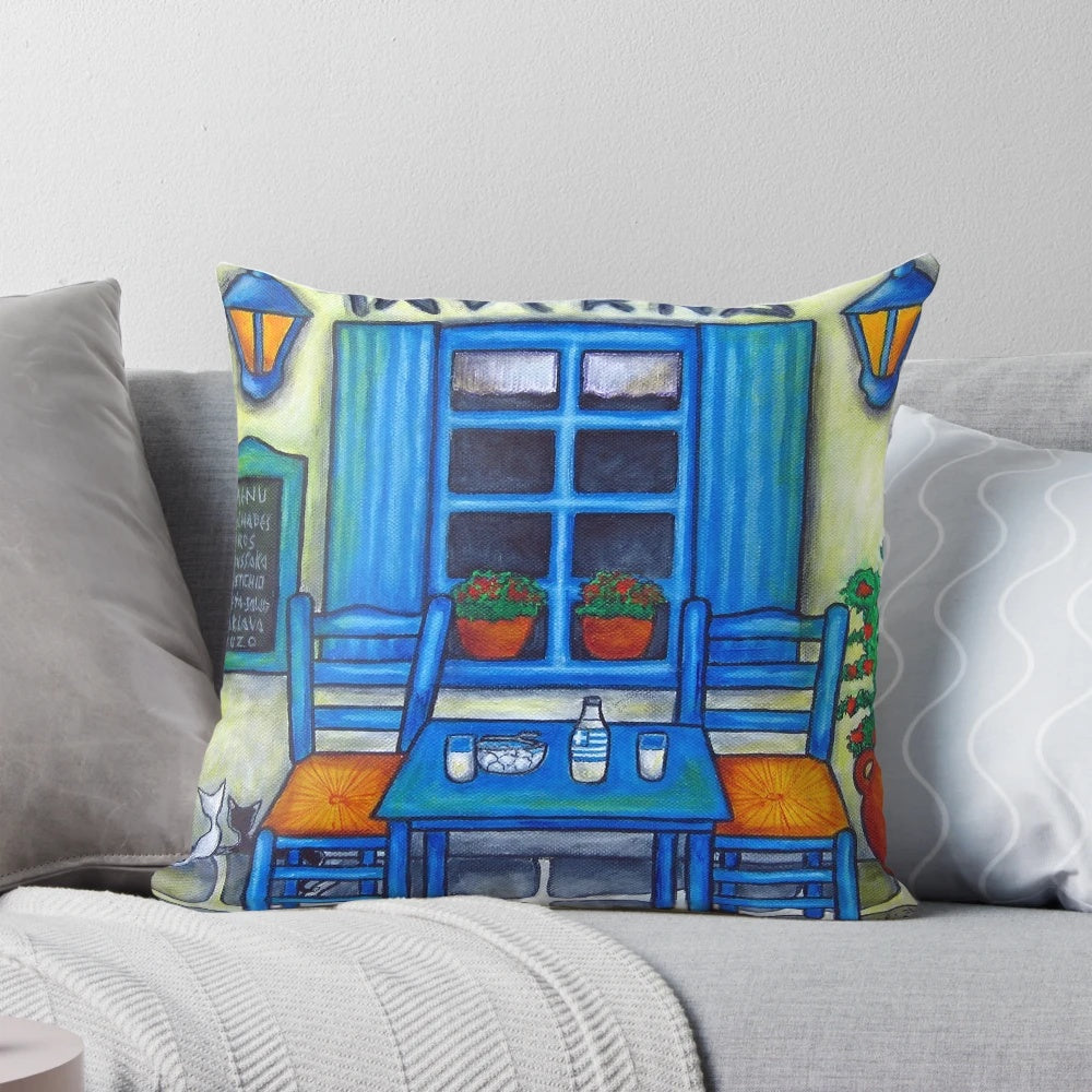 Vibrant Greek-inspired decorative pillow featuring a table and chairs in a taverna setting