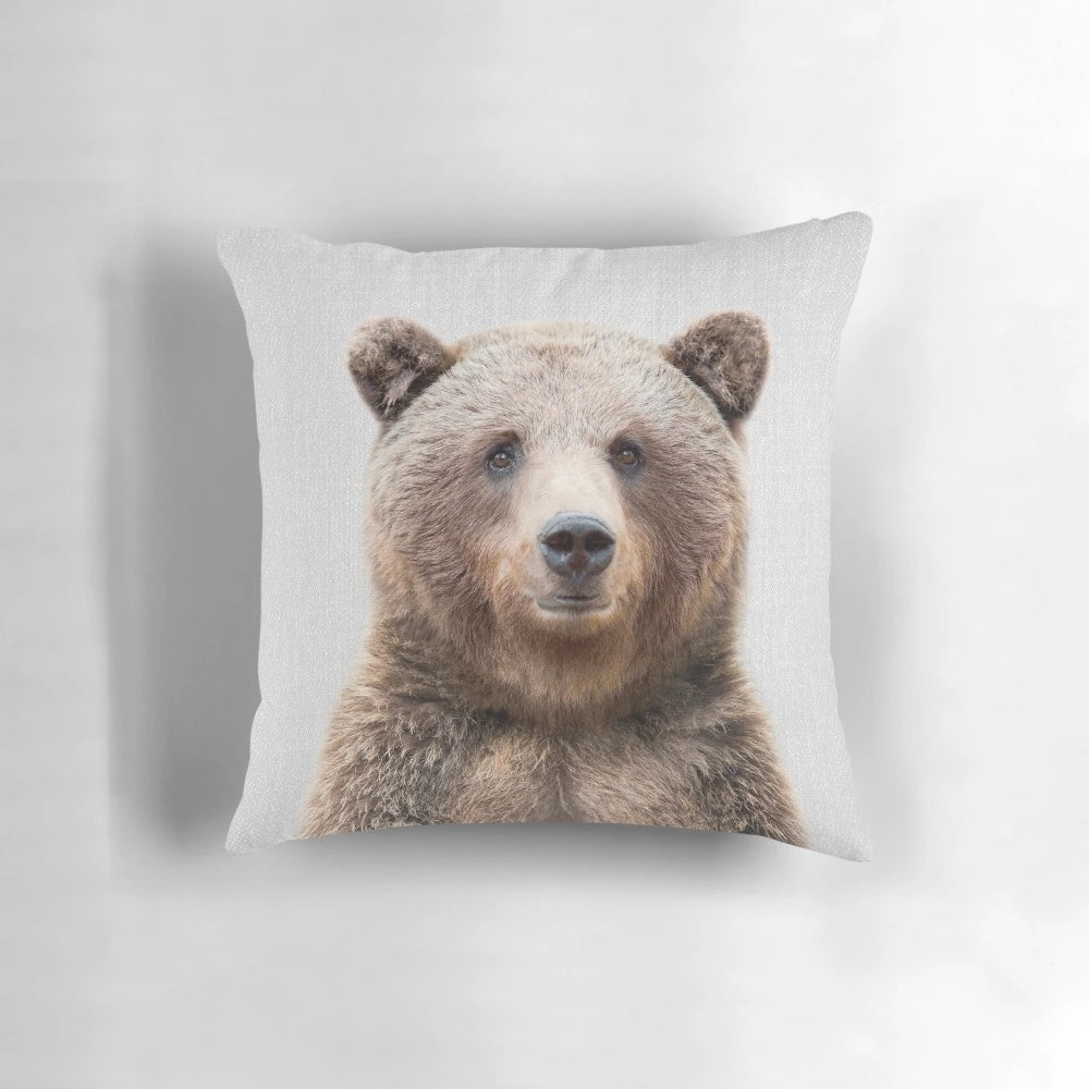 Vibrant illustration of a grizzly bear on a modern, minimalist throw pillow.