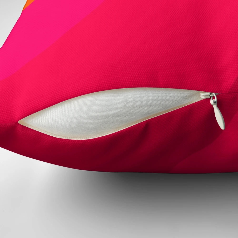 A vibrant hot pink to orange gradient throw pillow with a modern, minimalist design.