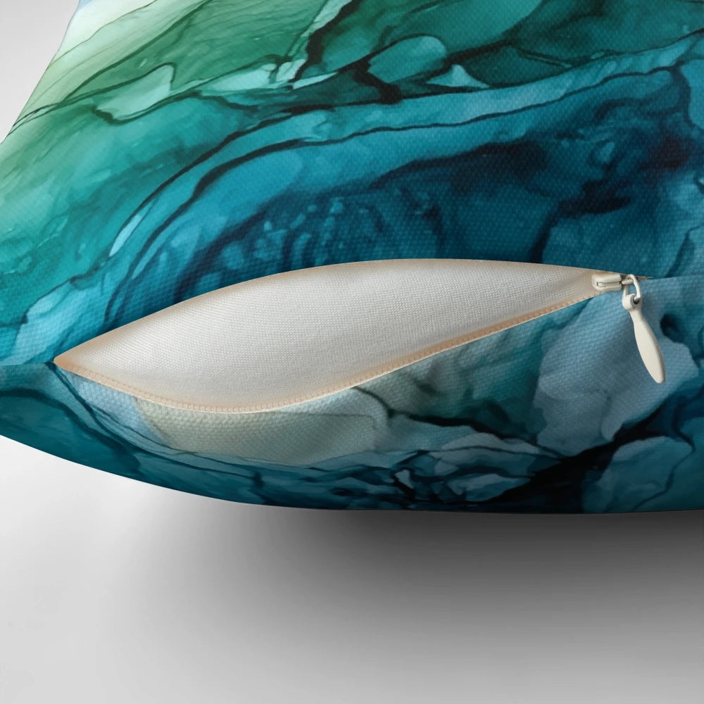 Vibrant abstract painting in shades of blue and orange on a decorative throw pillow, perfect for ocean-themed home decor.