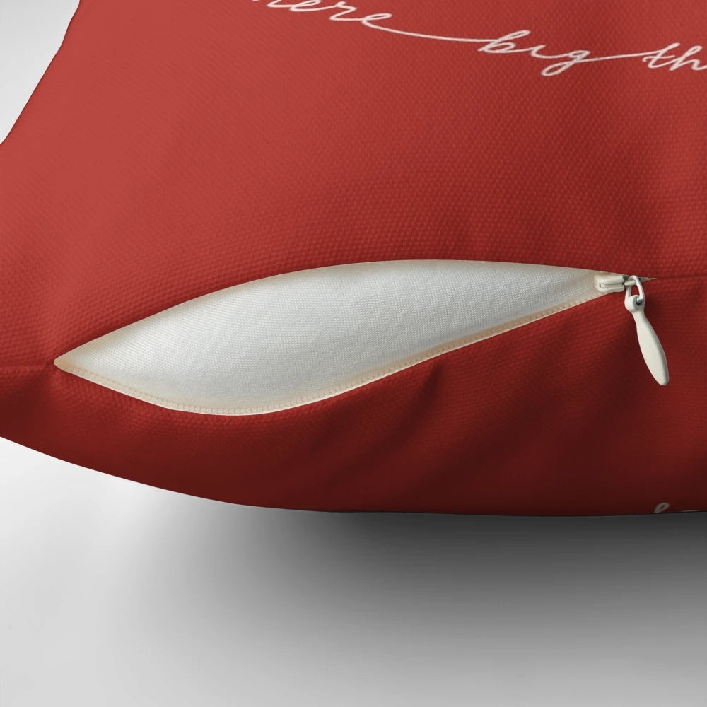 A red pillow with the text "A Small Place Where Big Things Happen
