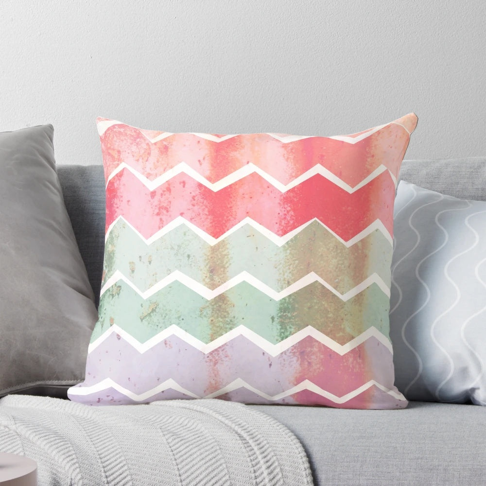 Corrugated chevron striped pillow with a vintage, geometric pattern in shades of green, pink, and purple.