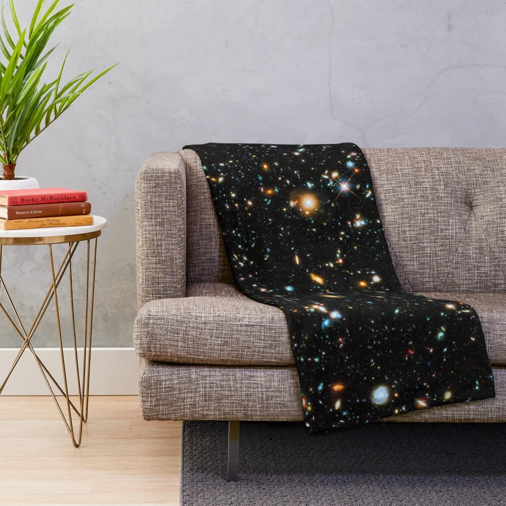 Hubble deep field inspired plush blanket with star field and galaxy design