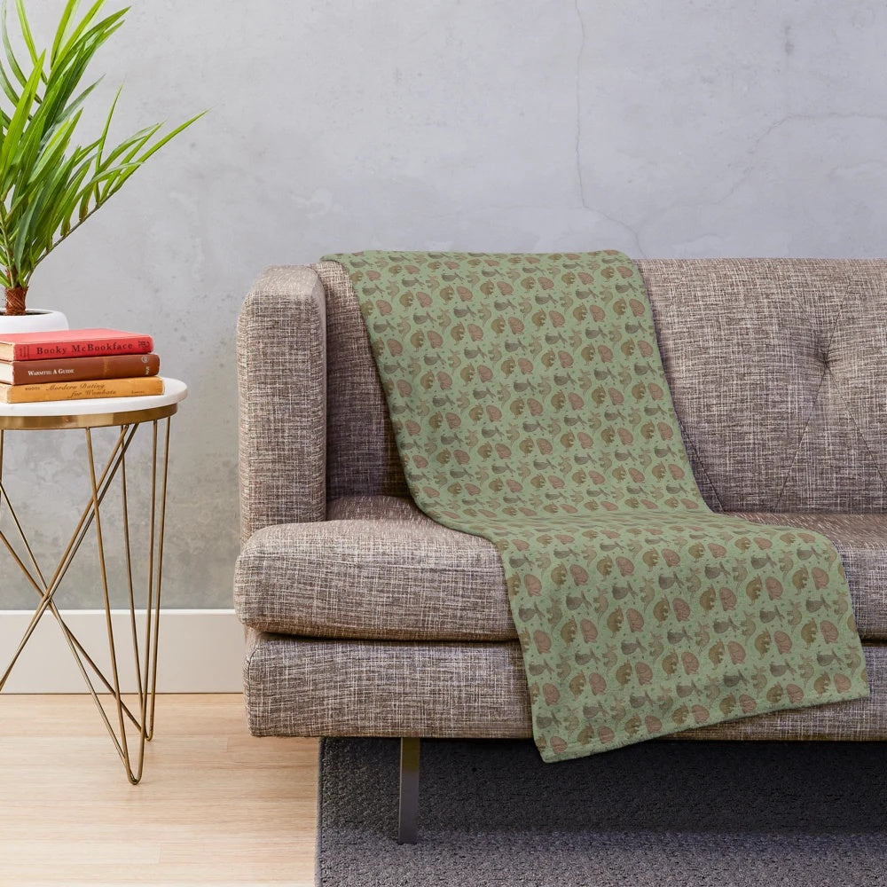 Aardvark plush blanket with a green leaf pattern