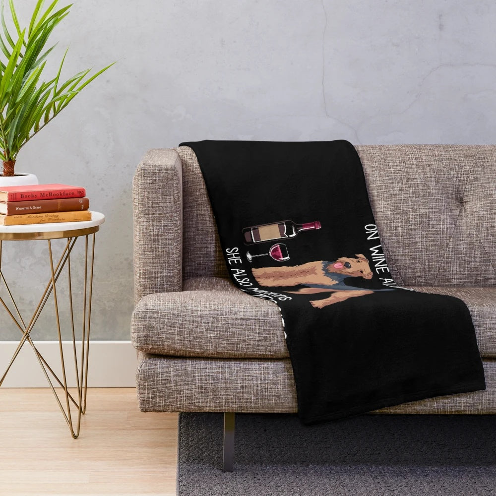 Airedale Terrier plush blanket with a playful dog and wine design