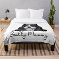 American Bully dog mom cuddling her puppy on a soft, plush blanket