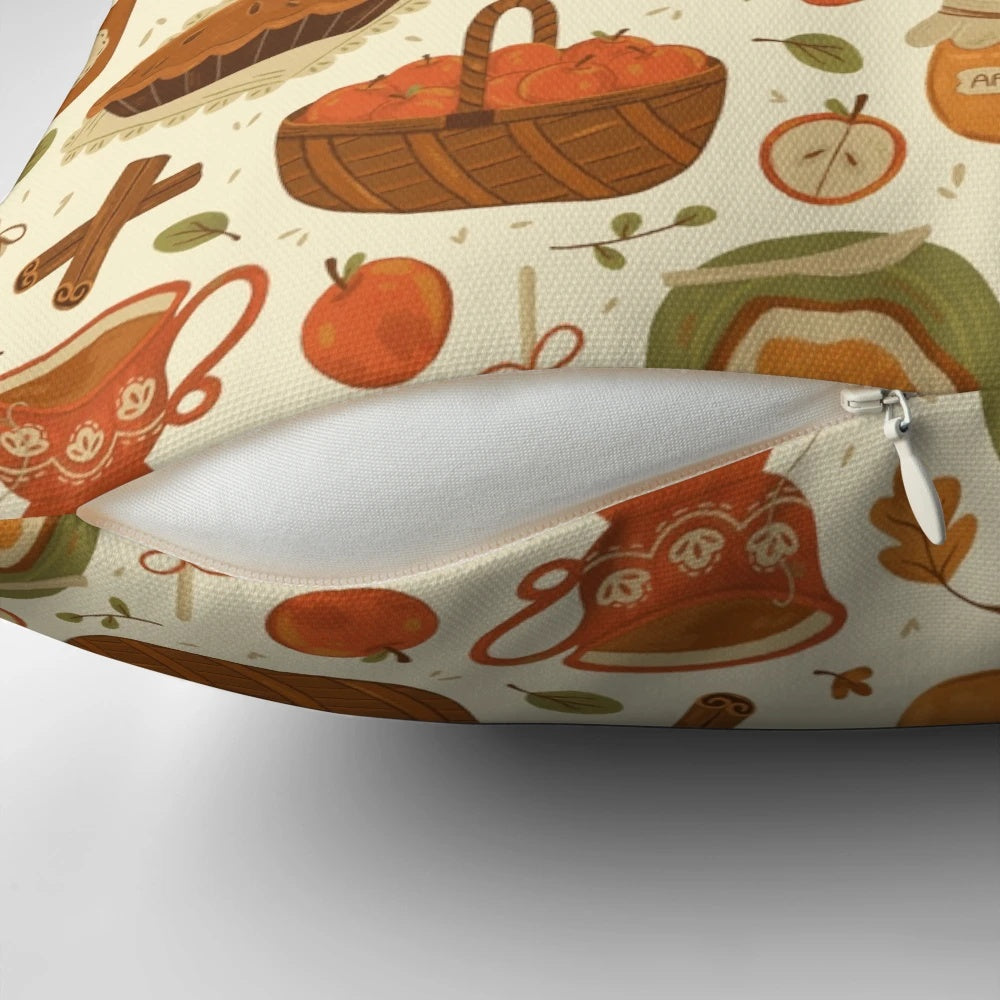 Close-up of a decorative autumn-themed pillow with apples, leaves, and a mason jar design