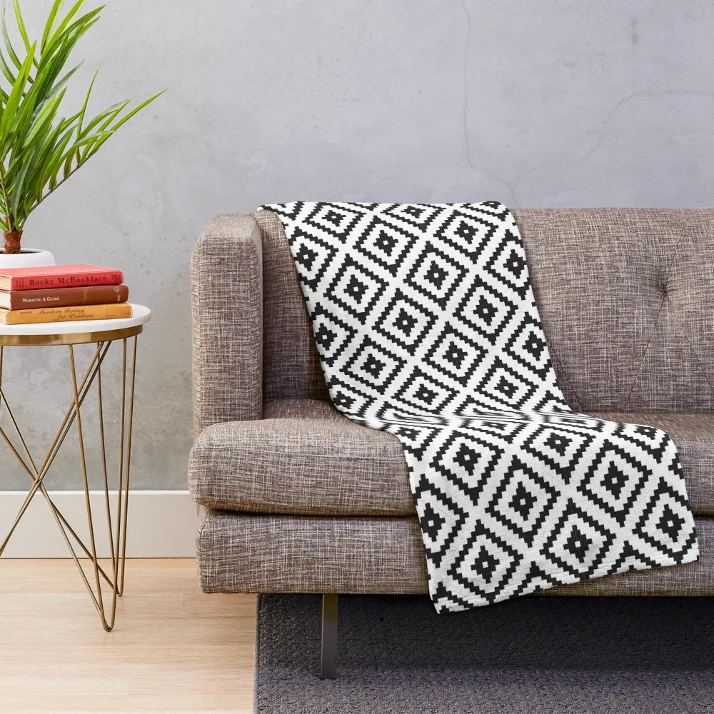 Soft, plush black and white blanket with Aztec-inspired tribal pattern design