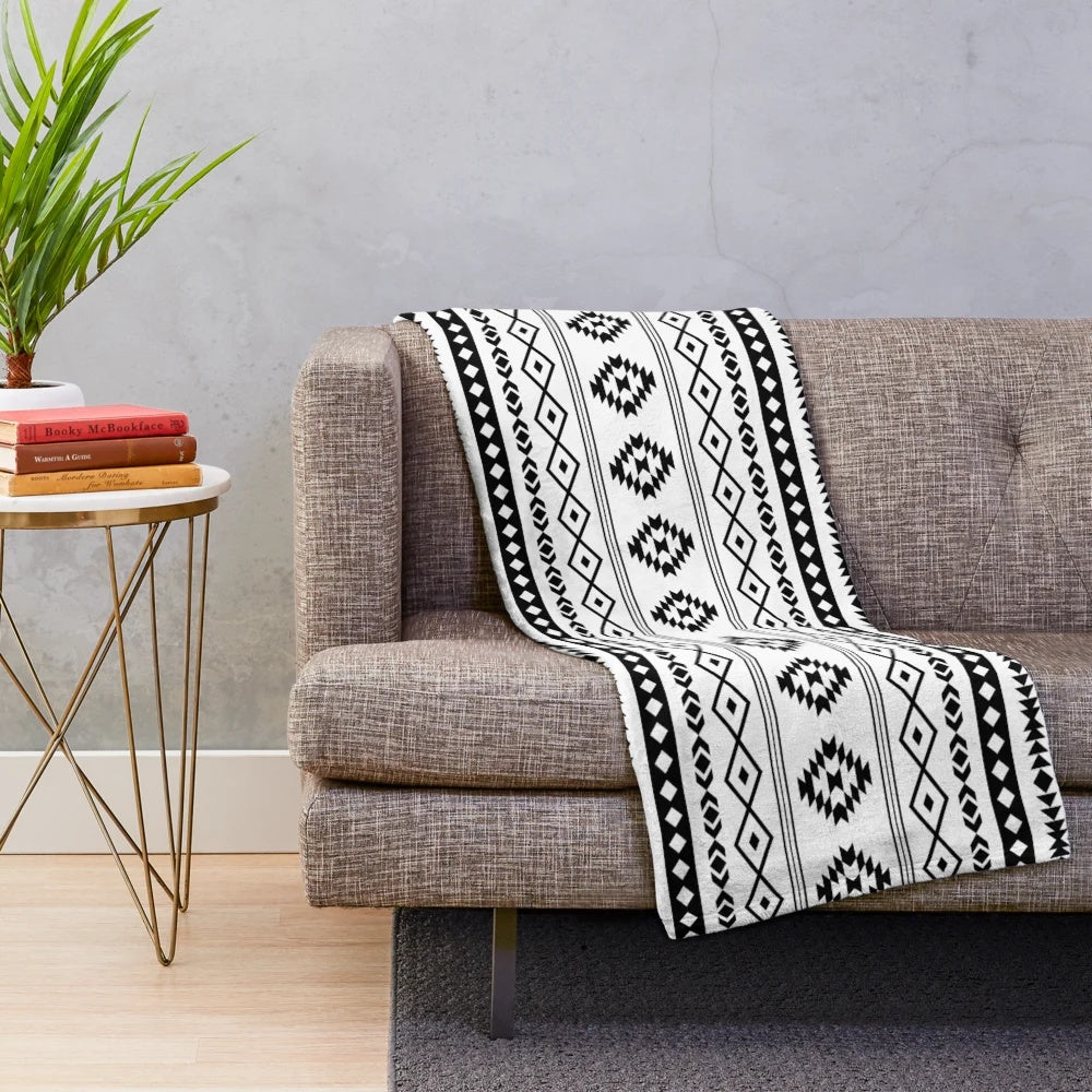Soft, plush blanket featuring an Aztec-inspired black and white tribal pattern design