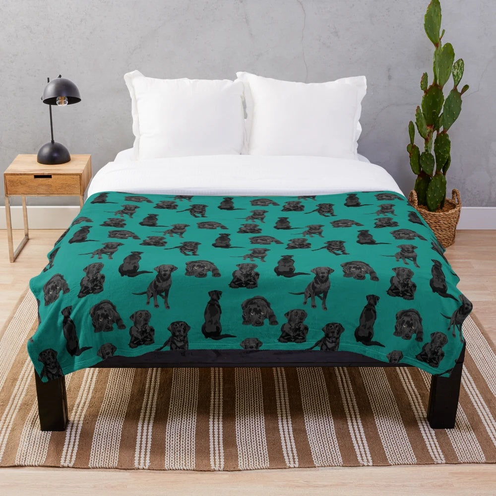 Black labrador retriever dog on a soft, plush blanket
