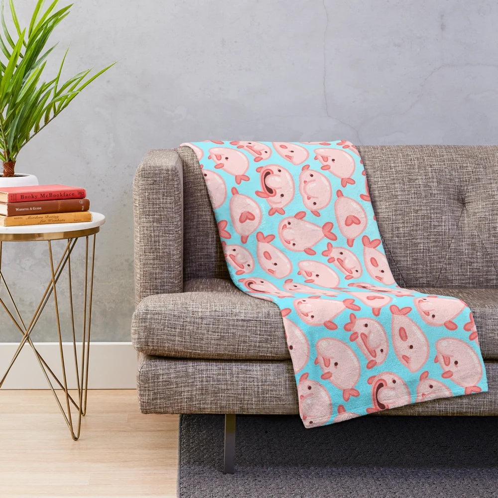 Soft and cuddly plush blanket featuring a cute blobfish pattern design